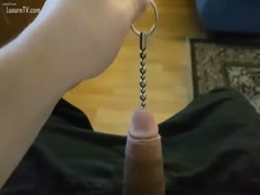 A young man sliding metal braided wire down his jock gap in an insane knob insertion film